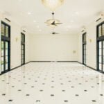 Spacious and elegant Grand Hall at The Agam, featuring chandeliers, large windows, and modern lighting for weddings and events.